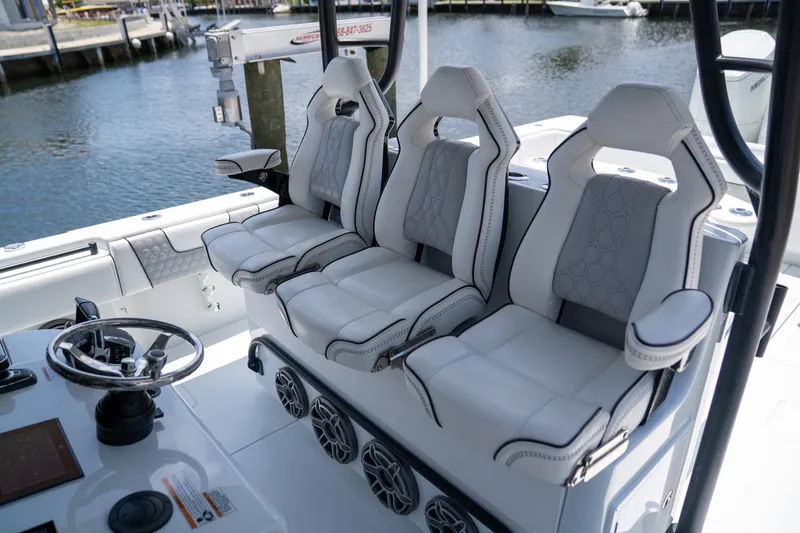 Pharma-sea Yacht Photos Pics 2023 Contender 44 CB boat interior with three luxury seats and steering wheel.