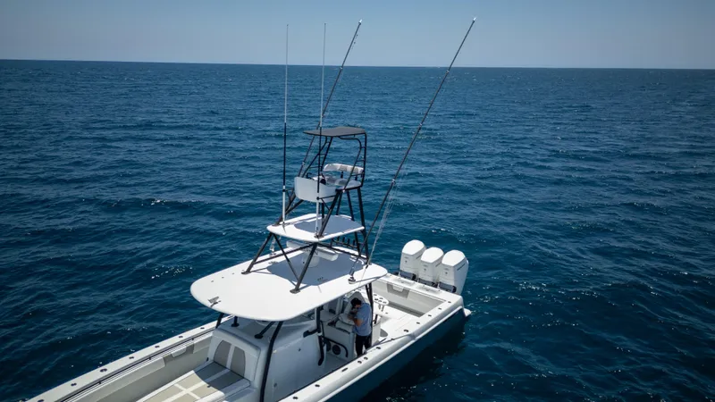 Pharma-sea Yacht Photos Pics 2023 Contender 44 CB boat on open ocean, featuring multiple outboard engines.