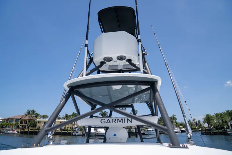 Pharma-sea Yacht Photos Pics 2023 Contender 44 CB boat with Garmin equipment, viewed from below, against a clear blue sky.