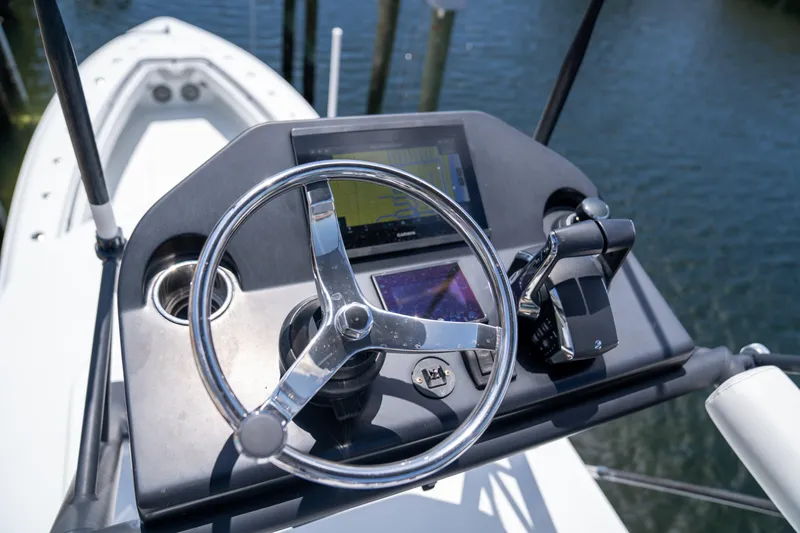 Pharma-sea Yacht Photos Pics Steering console of 2023 Contender 44 CB boat with navigation controls.