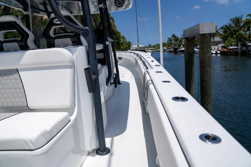 Pharma-sea Yacht Photos Pics 2023 Contender 44 CB boat docked on a sunny day, showcasing sleek design and seating.