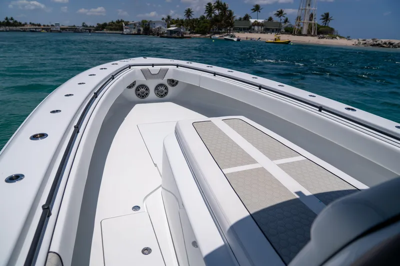 Pharma-sea Yacht Photos Pics 2023 Contender 44 CB boat on clear blue water near a tropical shoreline.