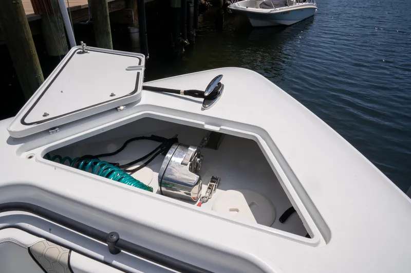 Pharma-sea Yacht Photos Pics 2023 Contender 44 CB boat with open storage compartment, docked by the water.