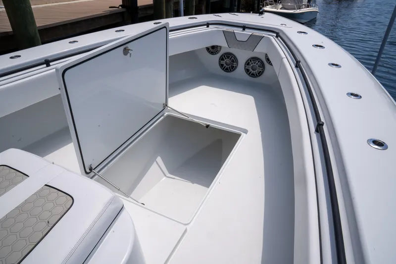 Pharma-sea Yacht Photos Pics 2023 Contender 44 CB boat with open storage compartment and speakers on deck.