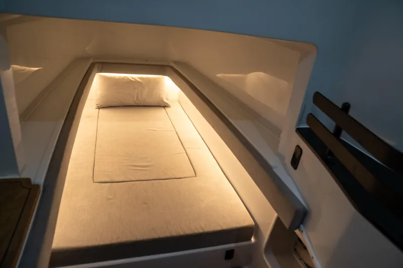 Pharma-sea Yacht Photos Pics 2023 Contender 44 CB cabin interior with cozy bed and ambient lighting.