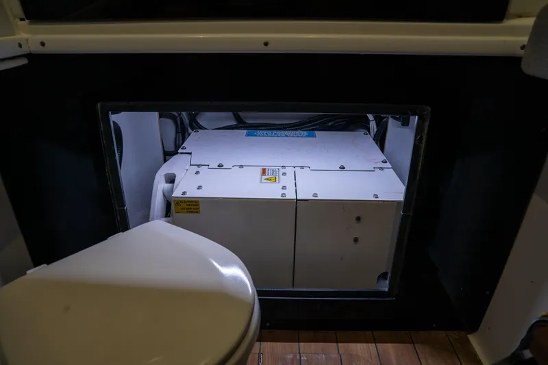 Pharma-sea Yacht Photos Pics 2023 Contender 44 CB boat interior showing a generator compartment and toilet.