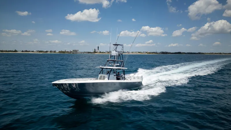 Pharma-sea Yacht Photos Pics 2023 Contender 44 CB boat cruising on open water under a clear blue sky.