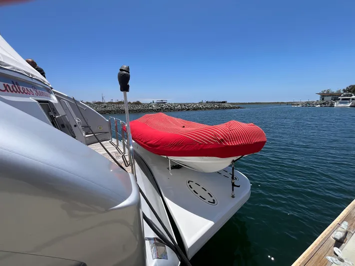 Endless Romance Yacht Photos Pics Astondoa 95GLX yacht (2001) docked with covered boat on deck, clear blue sky.