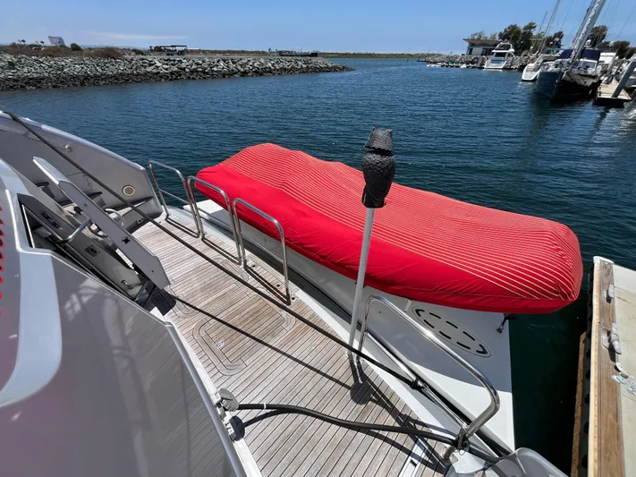 Endless Romance Yacht Photos Pics Astondoa 95GLX 2001 yacht deck with red-covered equipment, docked in a marina.