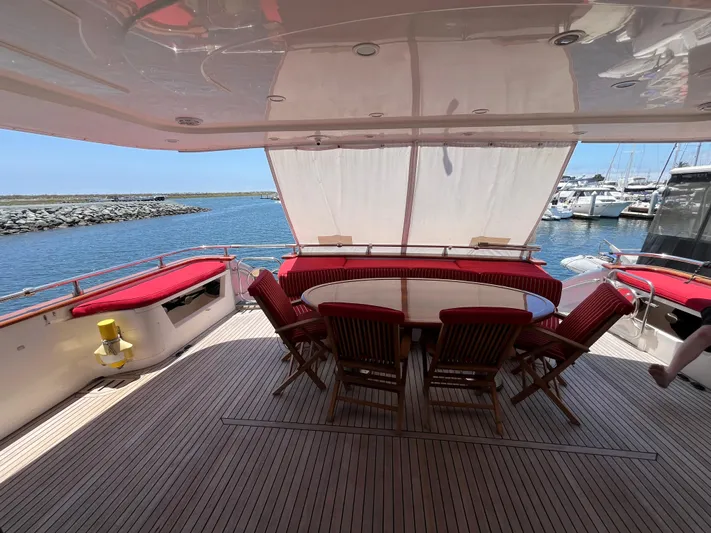 Endless Romance Yacht Photos Pics Astondoa 95GLX 2001 yacht deck with dining area, overlooking marina and ocean.
