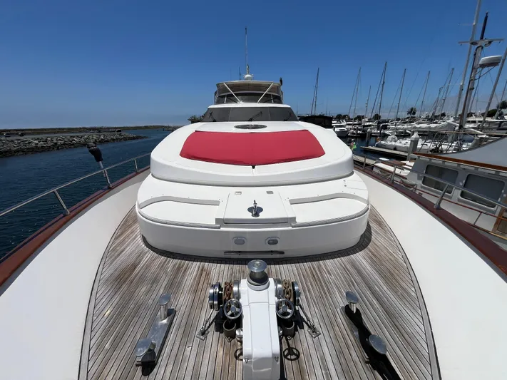 Endless Romance Yacht Photos Pics Astondoa 95GLX 2001 yacht with red sunpad, docked in marina under clear blue sky.