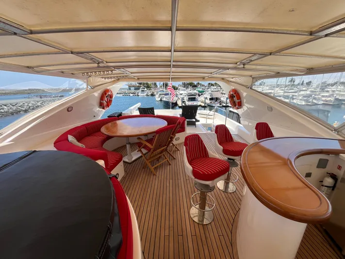 Endless Romance Yacht Photos Pics Luxurious 2001 Astondoa 95GLX yacht deck with seating, bar, and marina view.
