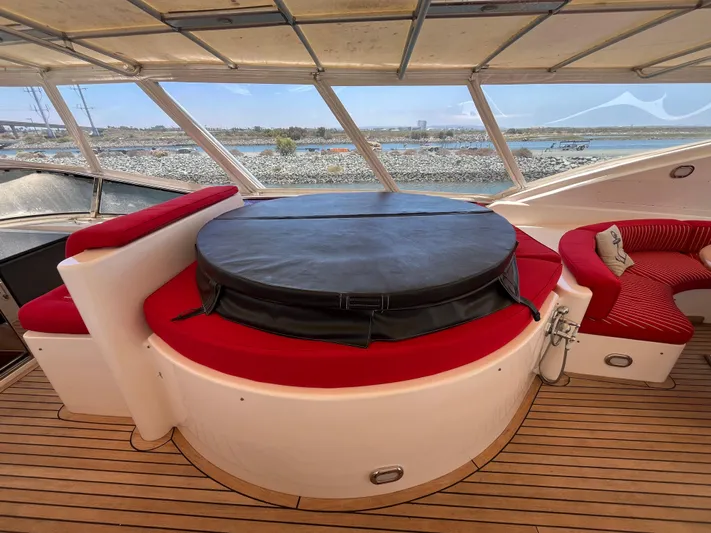 Endless Romance Yacht Photos Pics Luxurious 2001 Astondoa 95GLX yacht interior with red seating and covered hot tub.