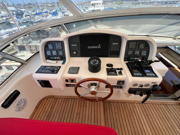 Endless Romance Yacht Photos Pics Cockpit of 2001 Astondoa 95GLX yacht with Garmin navigation system and wooden steering wheel.