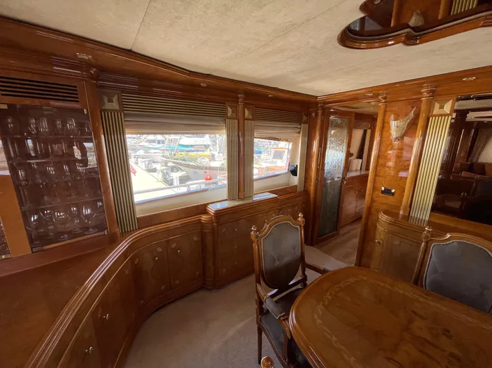 Endless Romance Yacht Photos Pics Luxurious interior of 2001 Astondoa 95GLX yacht with elegant wood finishes and dining area.