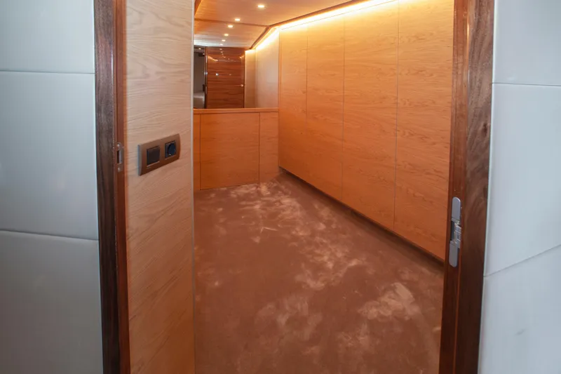  Yacht Photos Pics Luxurious interior of 2019 Van den Hoven Executive 2100 yacht with wood paneling.