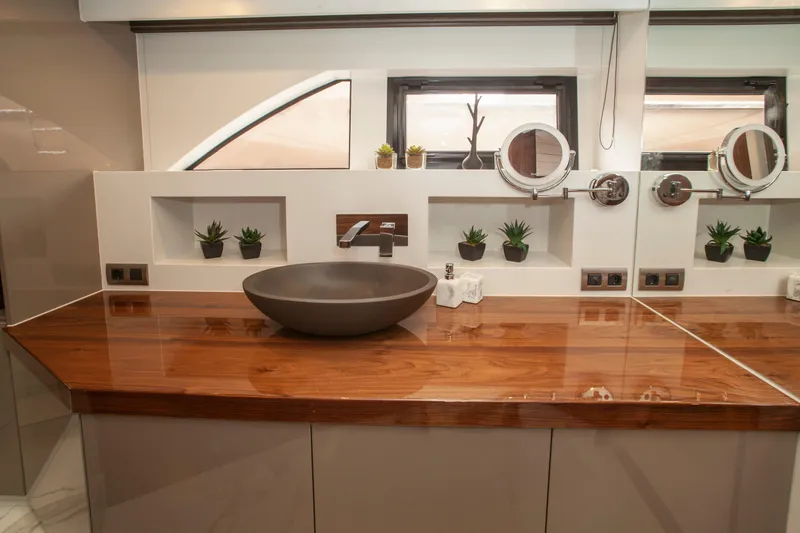  Yacht Photos Pics Luxurious bathroom in 2019 Van den Hoven Executive 2100 yacht with modern sink and wooden countertop.