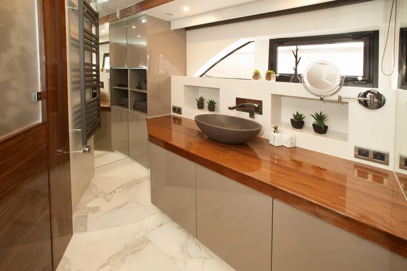  Yacht Photos Pics Luxurious bathroom in 2019 Van den Hoven Executive 2100 yacht with modern fixtures and elegant design.