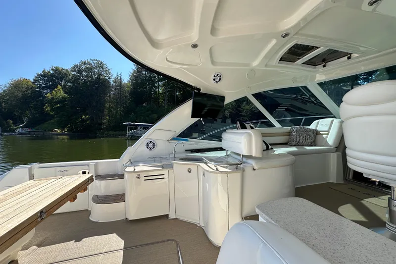  Yacht Photos Pics Luxurious 2009 Sea Ray 48 Sundancer yacht interior with seating, table, and scenic lake view.