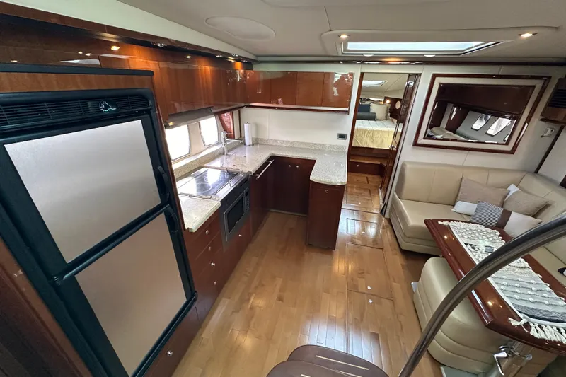 Yacht Photos Pics Luxurious interior of 2009 Sea Ray 48 Sundancer yacht with modern kitchen and seating area.