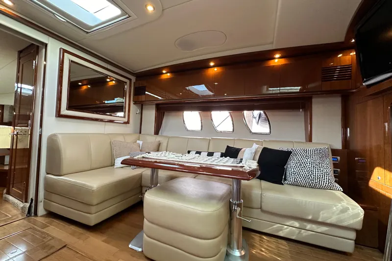  Yacht Photos Pics Luxurious interior of 2009 Sea Ray 48 Sundancer yacht with plush seating and elegant decor.