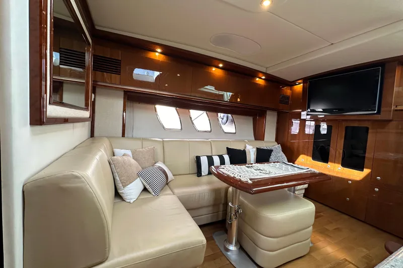  Yacht Photos Pics Luxurious interior of 2009 Sea Ray 48 Sundancer yacht with plush seating and elegant decor.