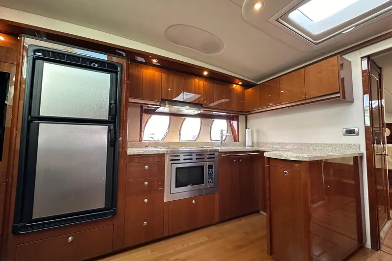  Yacht Photos Pics Luxurious kitchen interior of 2009 Sea Ray 48 Sundancer yacht with modern appliances.
