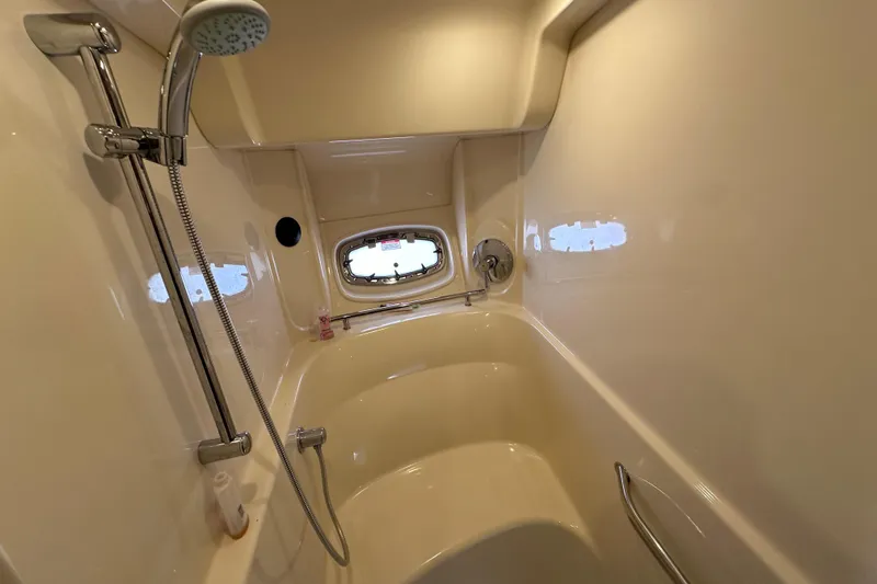  Yacht Photos Pics Luxurious bathroom in 2009 Sea Ray 48 Sundancer yacht with shower and porthole window.
