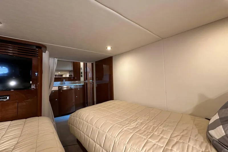  Yacht Photos Pics Interior cabin of 2009 Sea Ray 48 Sundancer yacht with twin beds and TV.