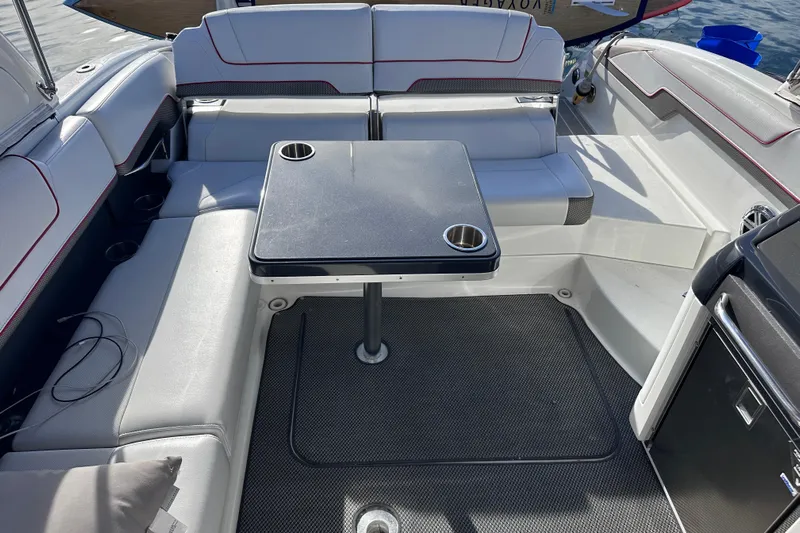  Yacht Photos Pics 2019 Formula 310 Bowrider interior with seating and table, featuring cup holders.