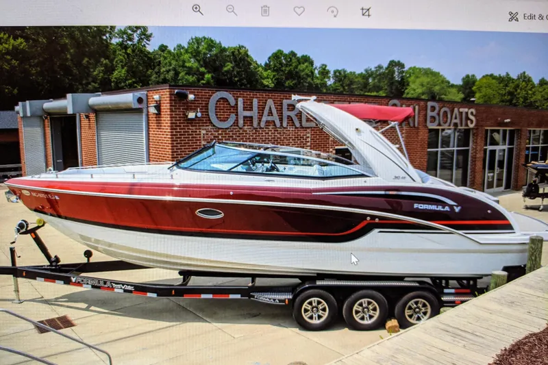  Yacht Photos Pics 2019 Formula 310 Bowrider boat on trailer at dealership, red and white design.