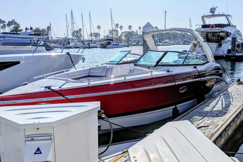  Yacht Photos Pics 2019 Formula 310 Bowrider docked at marina, surrounded by other boats.