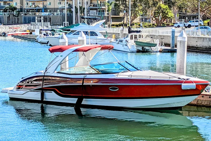  Yacht Photos Pics 2019 Formula 310 Bowrider boat docked in a marina, featuring sleek design and vibrant colors.