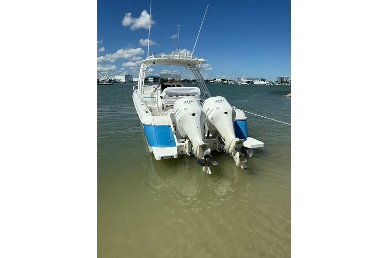 Insignia Yacht Photos Pics 2015 Intrepid 327 Cuddy boat with twin outboard engines in shallow water.
