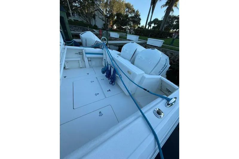 Insignia Yacht Photos Pics 2015 Intrepid 327 Cuddy boat with Yamaha engines, docked with blue ropes.