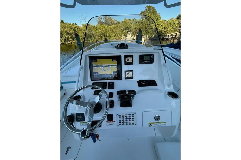 Insignia Yacht Photos Pics 2015 Intrepid 327 Cuddy boat dashboard with navigation screens and steering wheel.