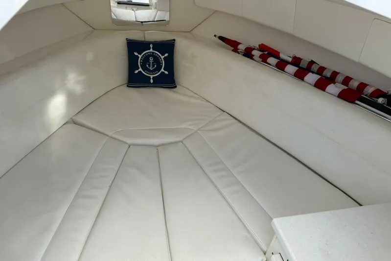 Insignia Yacht Photos Pics 2015 Intrepid 327 Cuddy cabin interior with white seating and nautical-themed pillow.