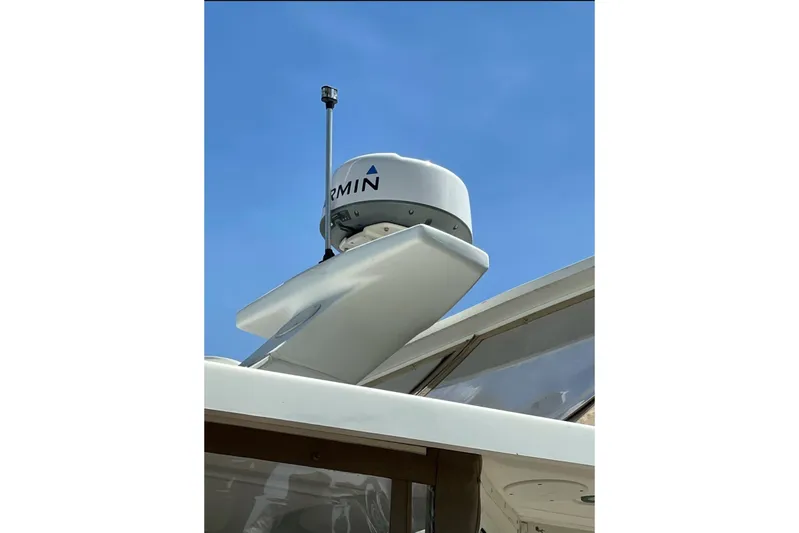 Living The Dream Yacht Photos Pics Radar equipment on a 1997 Silverton 402 Motor Yacht against a clear blue sky.