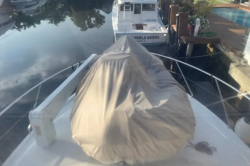 Living The Dream Yacht Photos Pics 1997 Silverton 402 Motor Yacht docked, covered, with calm water reflection.