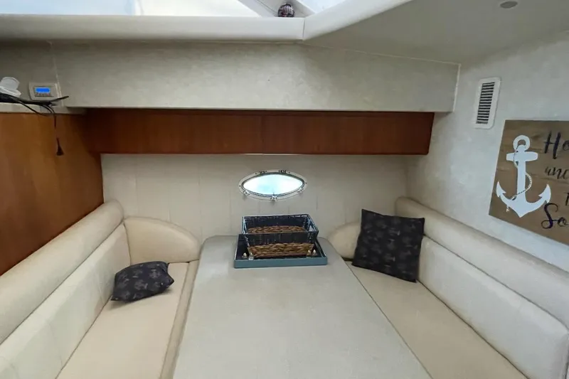 Living The Dream Yacht Photos Pics Interior of 1997 Silverton 402 Motor Yacht with cozy seating and nautical decor.
