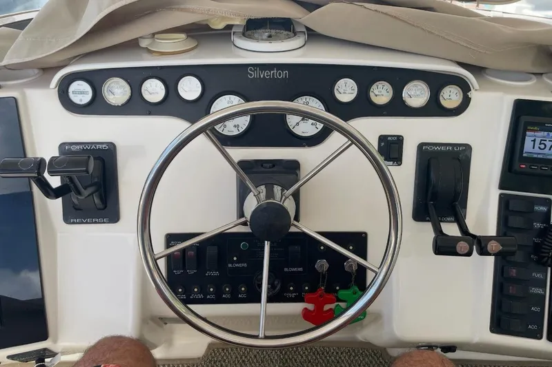 Living The Dream Yacht Photos Pics 1997 Silverton 402 Motor Yacht helm with steering wheel and control panel.