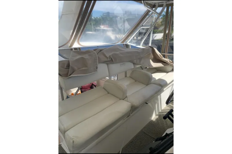 Living The Dream Yacht Photos Pics 1997 Silverton 402 Motor Yacht interior with white seating and covered helm area.