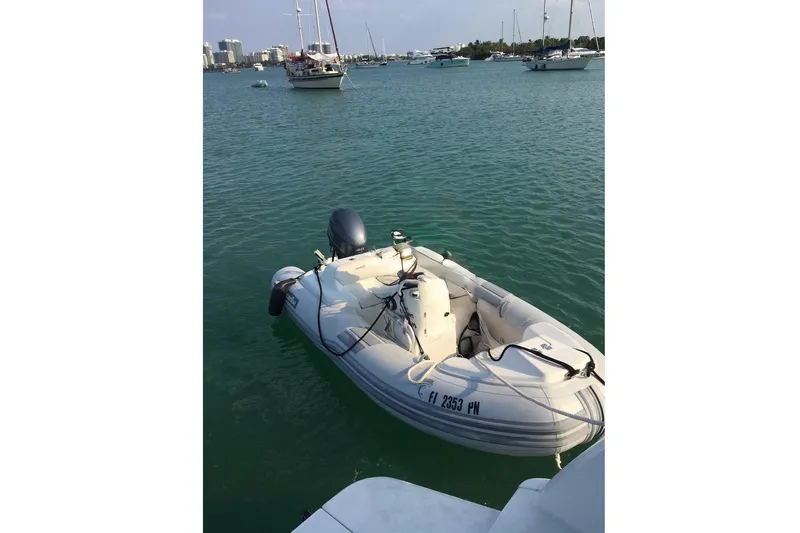 Living The Dream Yacht Photos Pics Inflatable boat docked on water near Silverton 402 Motor Yacht, 1997 model.