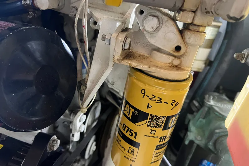 Living The Dream Yacht Photos Pics Engine component of a 1997 Silverton 402 Motor Yacht with CAT filter and handwritten date.