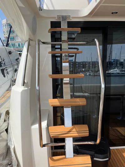 Simorgh Yacht Photos Pics Staircase on a 2019 Prestige 460 yacht with marina background.