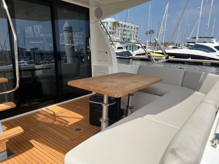 Simorgh Yacht Photos Pics Prestige 460 yacht 2019 model with outdoor seating and table at marina.