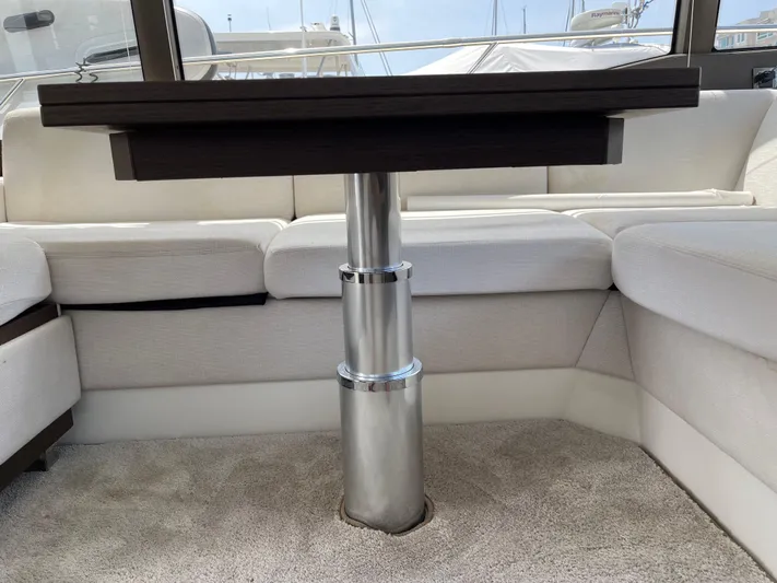 Simorgh Yacht Photos Pics Interior seating and table of a 2019 Prestige 460 yacht.