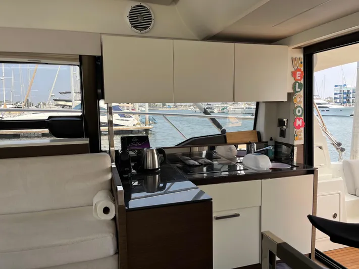 Simorgh Yacht Photos Pics Interior of 2019 Prestige 460 yacht with modern kitchen and marina view.
