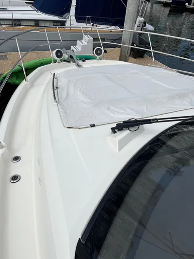 Simorgh Yacht Photos Pics 2019 Prestige 460 yacht bow with covered sunpad and marina background.
