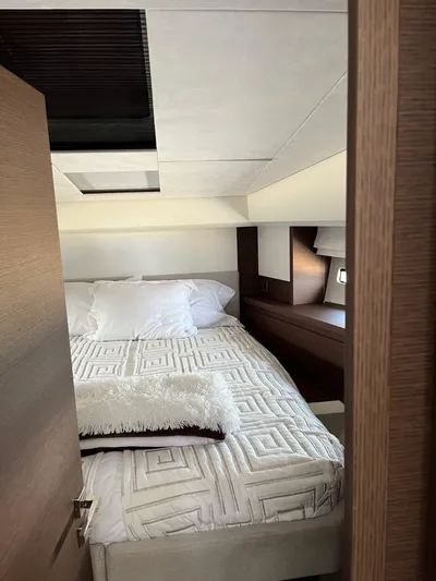 Simorgh Yacht Photos Pics 2019 Prestige 460 yacht bedroom with modern decor and cozy bedding.